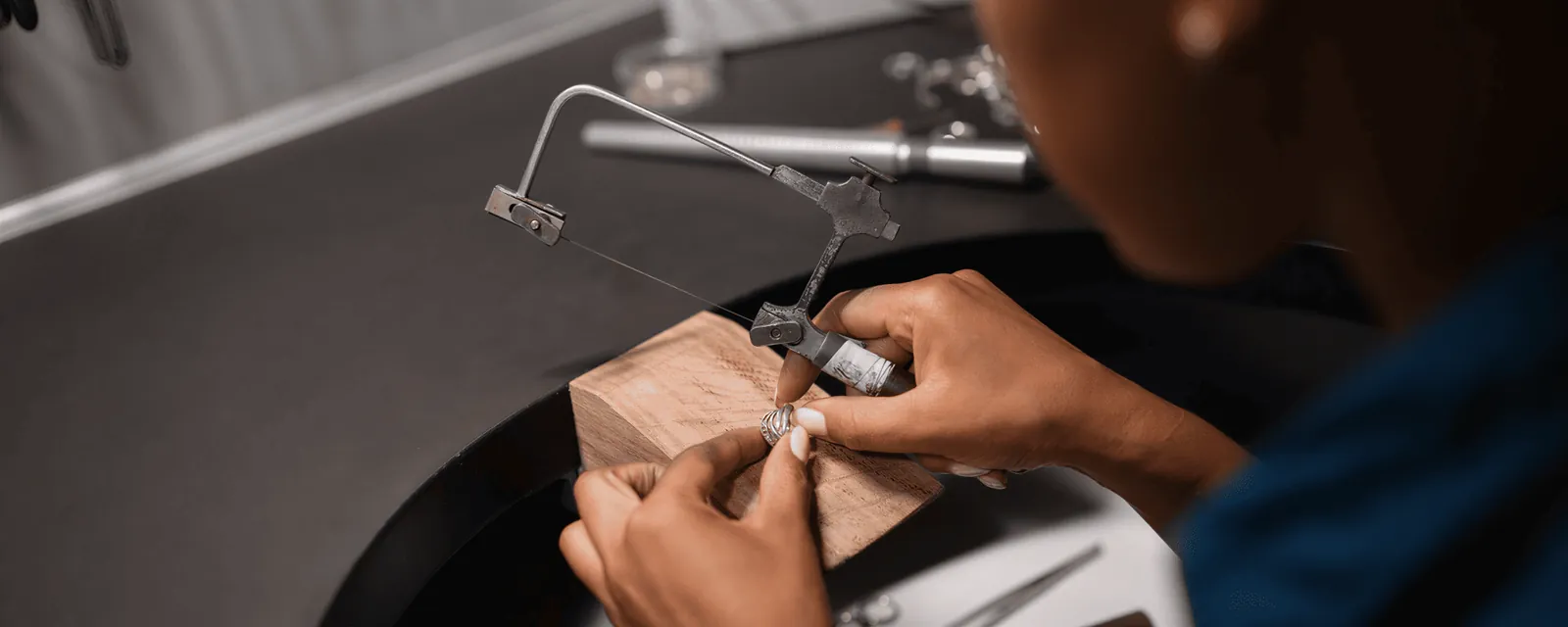 A Bryanston jeweller setting a stone at the bench